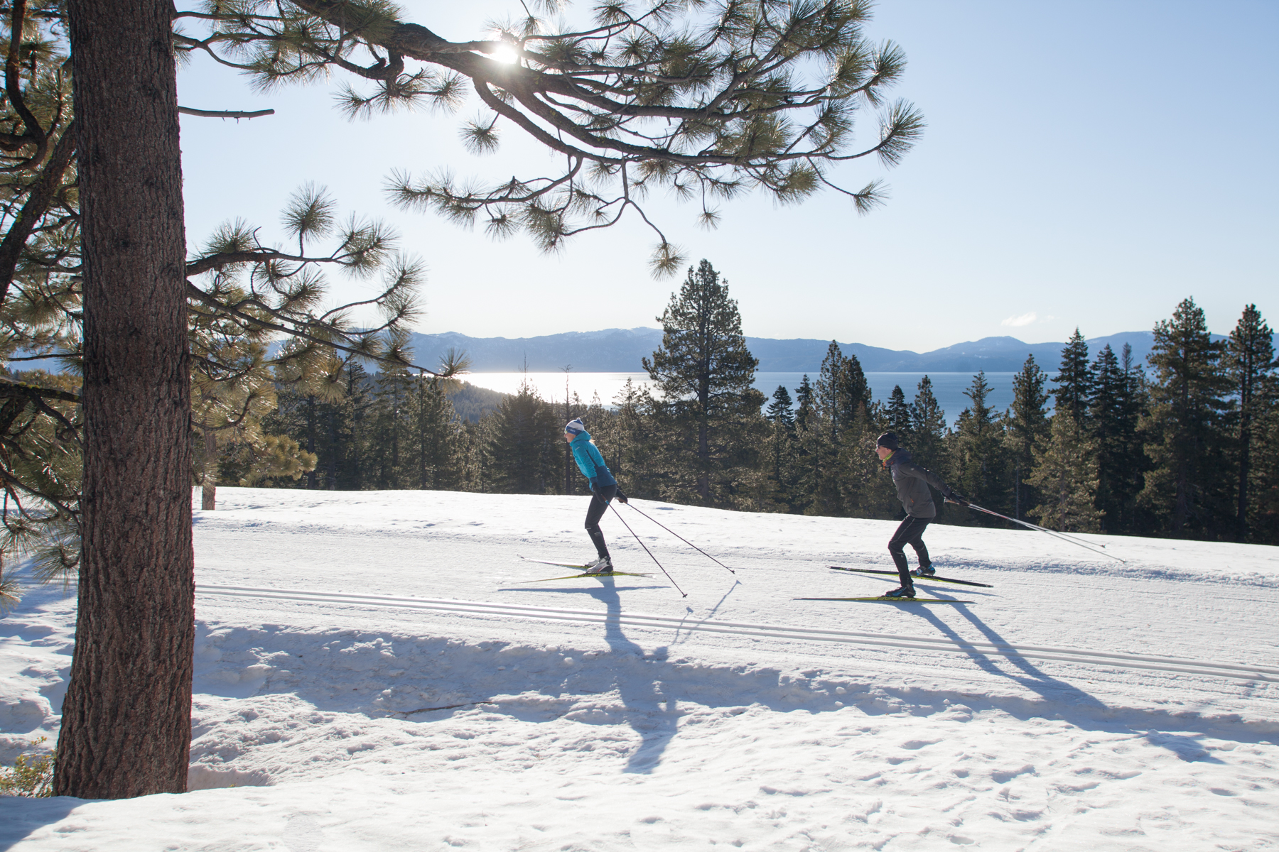 Two skiers with view of Lake Tahoe